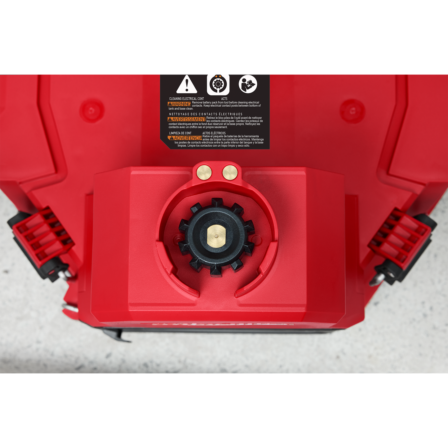 Top view of red and black backpack sprayer with secure cap and warning label for tools and home improvement use