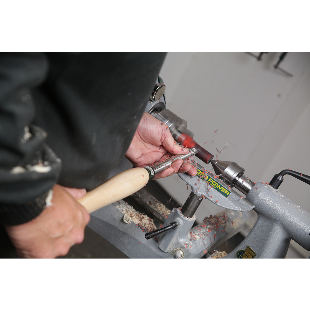 Hands using a woodturning tool with wooden handle on lathe shaping a wood piece for woodworking projects