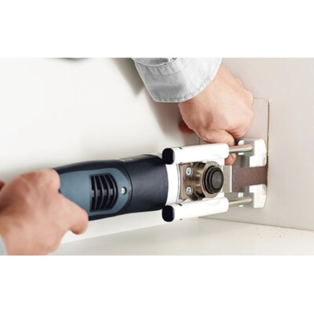 Power tool with Festool Vecturo plunge base and depth stop cutting precise recess in white wall for woodworking