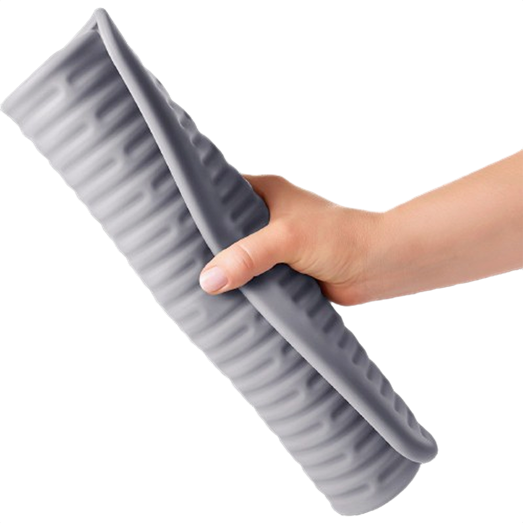 Hand holding flexible large gray silicone drying mat with ribbed texture for kitchen storage and organization