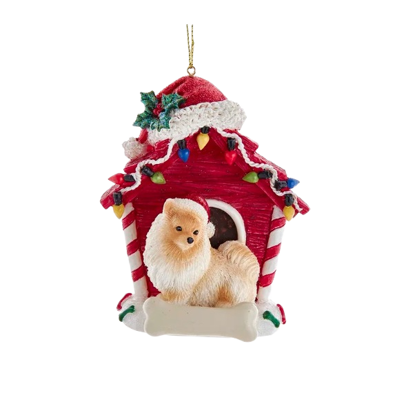 Festive Pomeranian figurine wearing a Santa hat in a red dog house decorated with holiday lights and holly leaves.