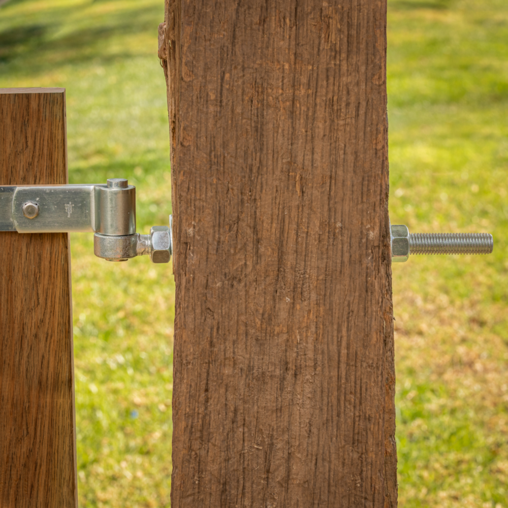 Zinc-plated steel hinge strap attached to wooden gate post for door and gate accessories in home improvement collections