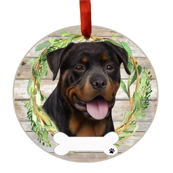 Round Christmas ornament featuring a happy Rottweiler face framed by green foliage wreath design