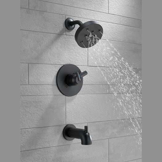 Modern matte black shower trim set with wall-mounted showerhead spraying water in bathroom with tiled wall
