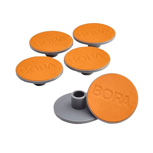 Six orange and gray non-slip tool feet with the brand name embossed, designed for enhanced grip in home improvement use