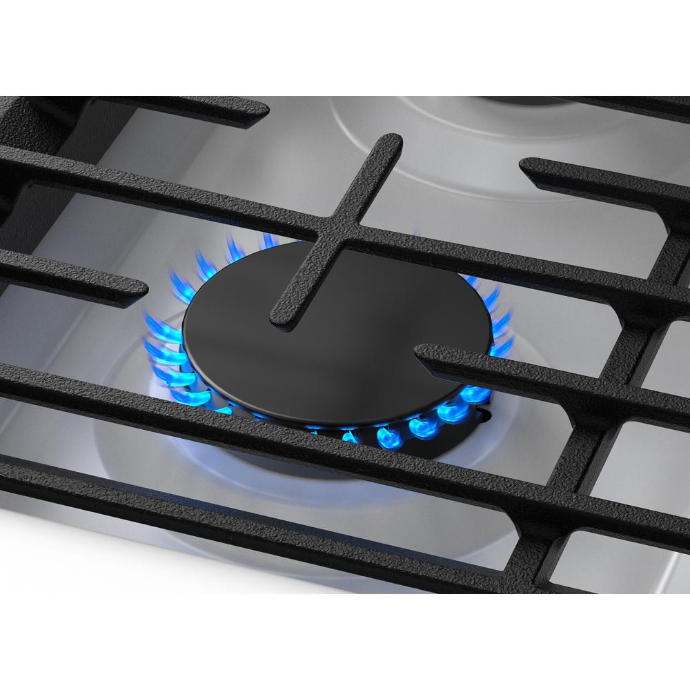 Close-up of blue flame burning on a black gas burner with cast iron grates from kitchen ranges and appliances collection
