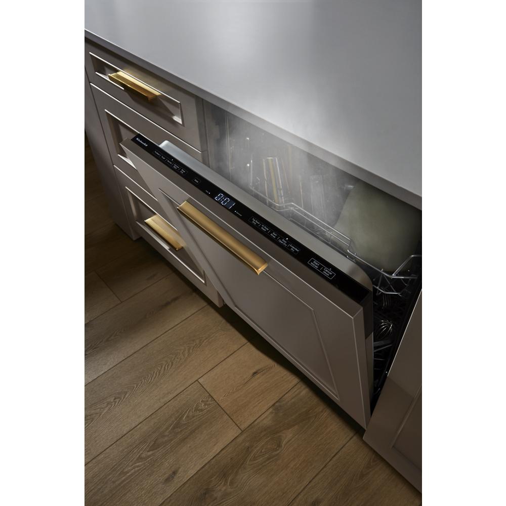 Built-in panel-ready dishwasher releasing steam with custom gray door and brass hardware in kitchen appliances category