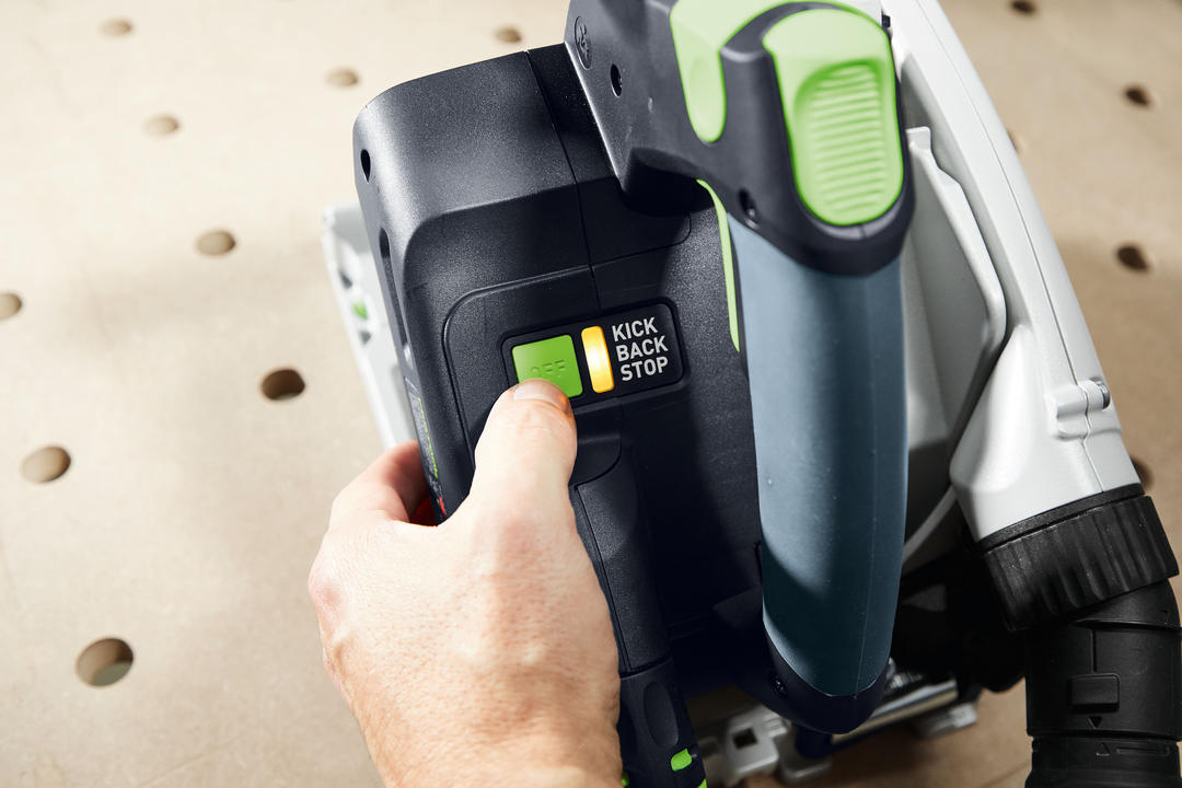 Hand activating Kickback Stop feature on Festool plunge cut track saw in power tools collection
