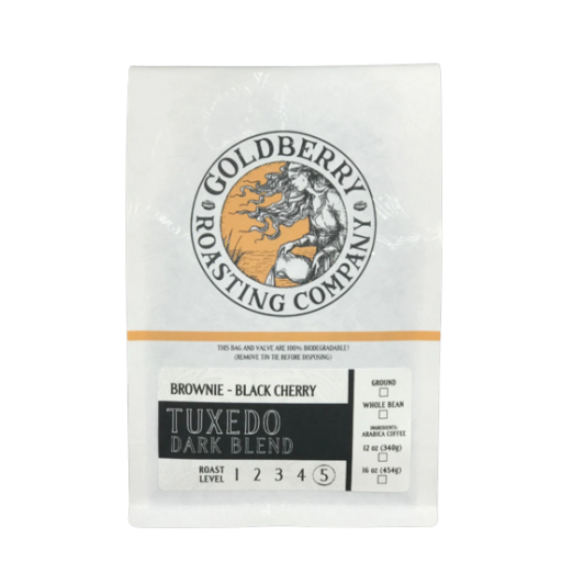 White bag of Goldberry Roasting Company Tuxedo dark blend ground coffee with black and orange label design