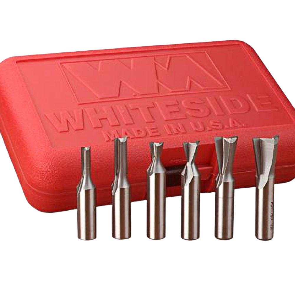 Six carbide-tipped router bits with 1/2 inch shanks displayed in front of a red tool accessories storage case