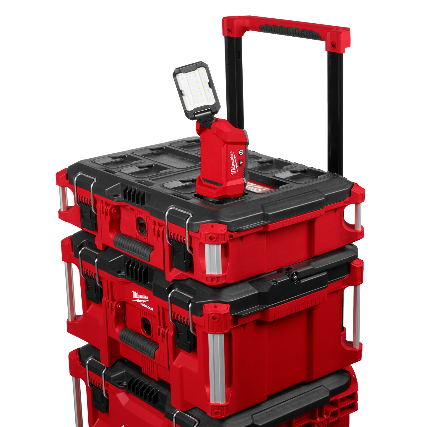 Compact red and black Milwaukee multi-directional LED flood light with adjustable head mounted on a red and black PACKOUT™ storage system, featured in work lights and woodworking tools collections at Hartville Hardware.