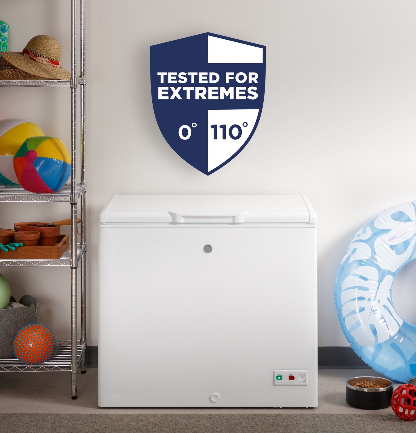 White chest freezer in a home setting with shelving, toys nearby, and a badge indicating tested for temperatures from 0 to 110 degrees