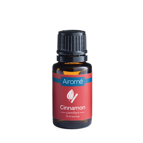 Amber glass bottle of cinnamon essential oil with red and blue label for home decor and fragrance use