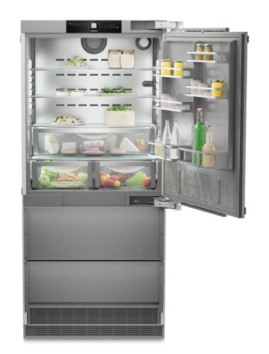Built-in stainless steel refrigerator with right hinge, adjustable shelves, vegetable crispers, and bottom freezer drawers in Appliances collection