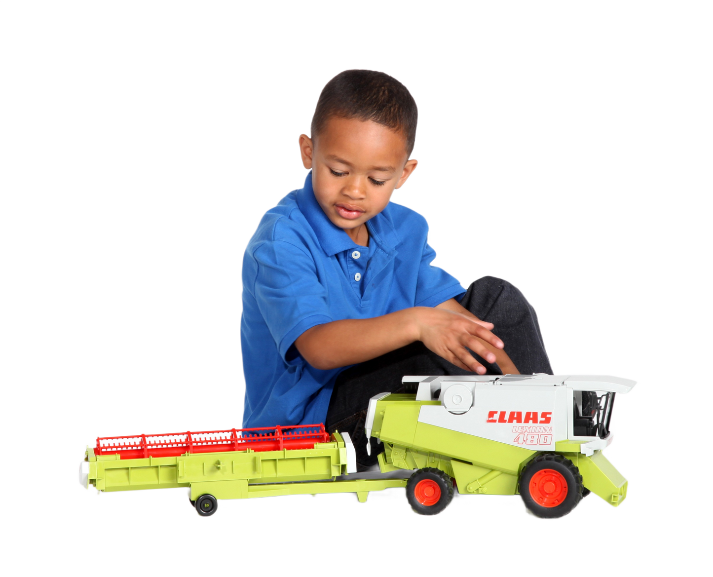 Young child in blue shirt playing with detailed green and white Bruder Claas Lexion 480 toy combine model