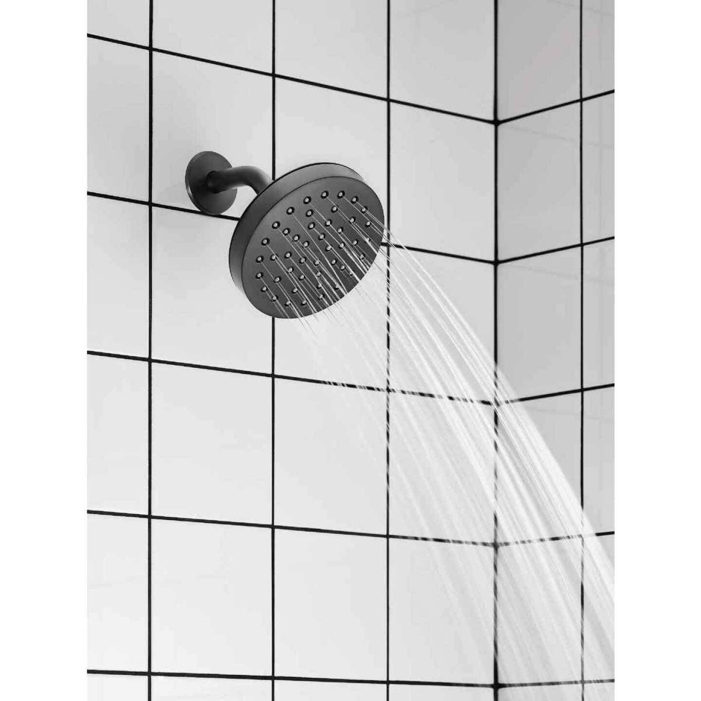 Matte black single-handle shower trim with rain shower spray head in tiled bathroom for modern bath and shower fixtures