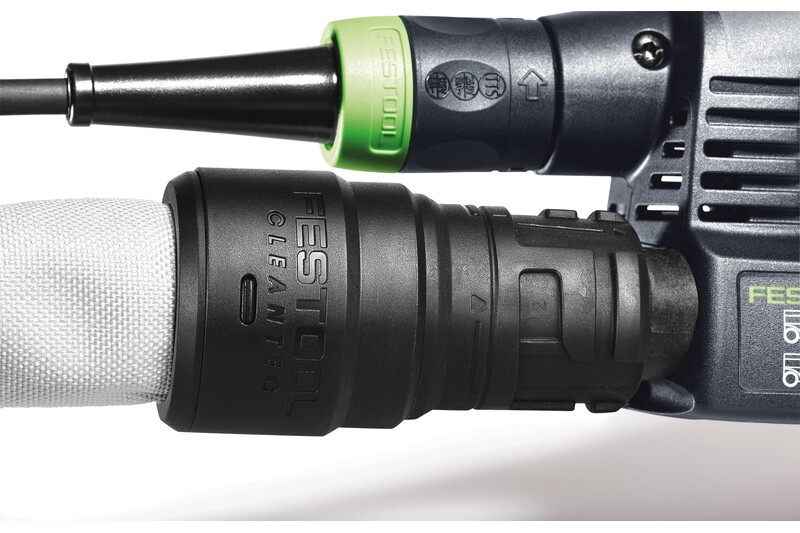 Close-up of Festool dust extraction hose with nylon sleeve attached to power tool for woodworking dust management.