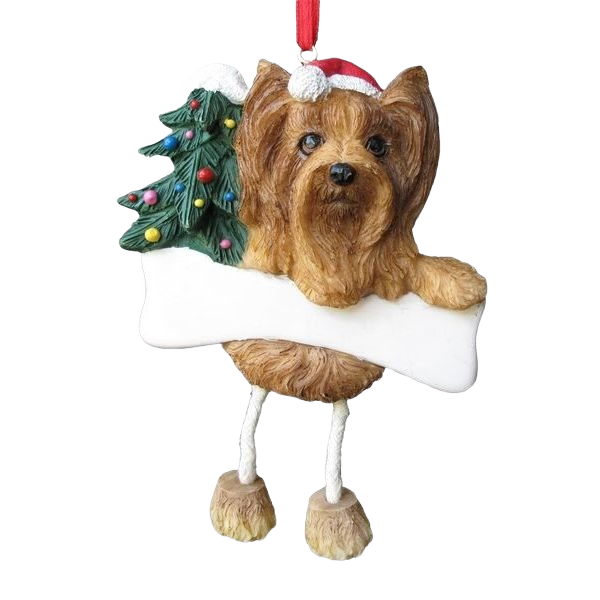Brown Yorkie dog ornament with dangling legs wearing Santa hat and decorated Christmas tree for holiday décor collections