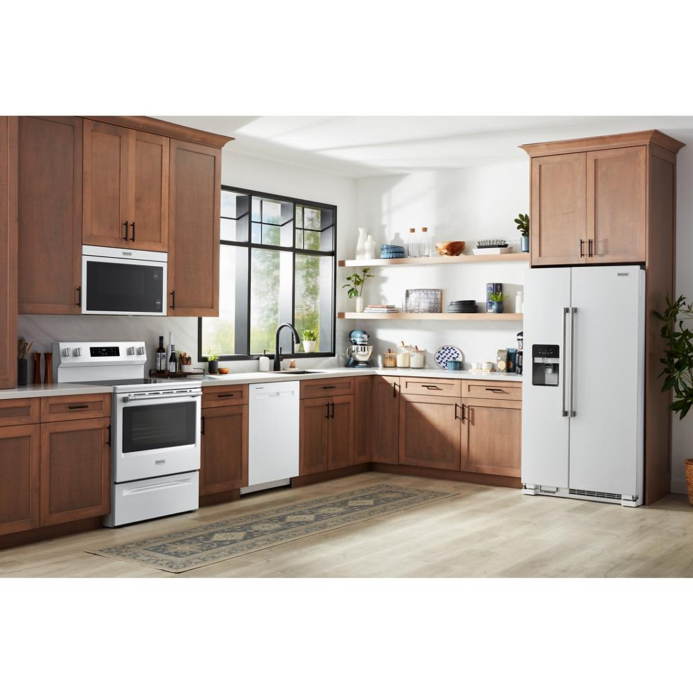Modern kitchen with wooden cabinetry featuring a white electric range, microwave, dishwasher, and side-by-side refrigerator