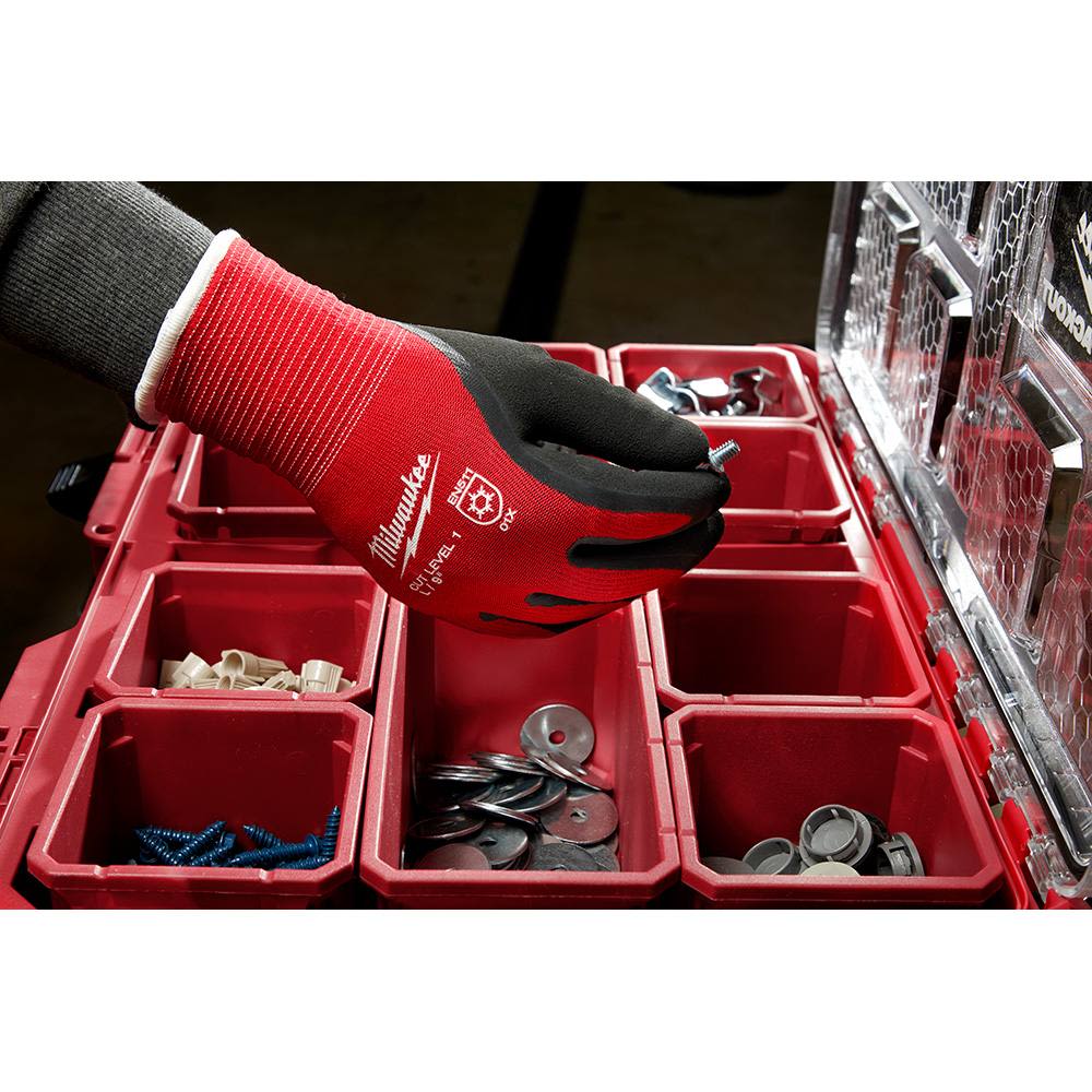 Red and black insulated work glove with cut level 1 protection sorting hardware in a red organizer for safety and tools use