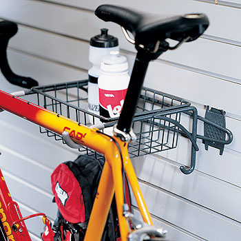 Wall-mounted metal bike rack with basket for garage storage and organization of cycling accessories and gear