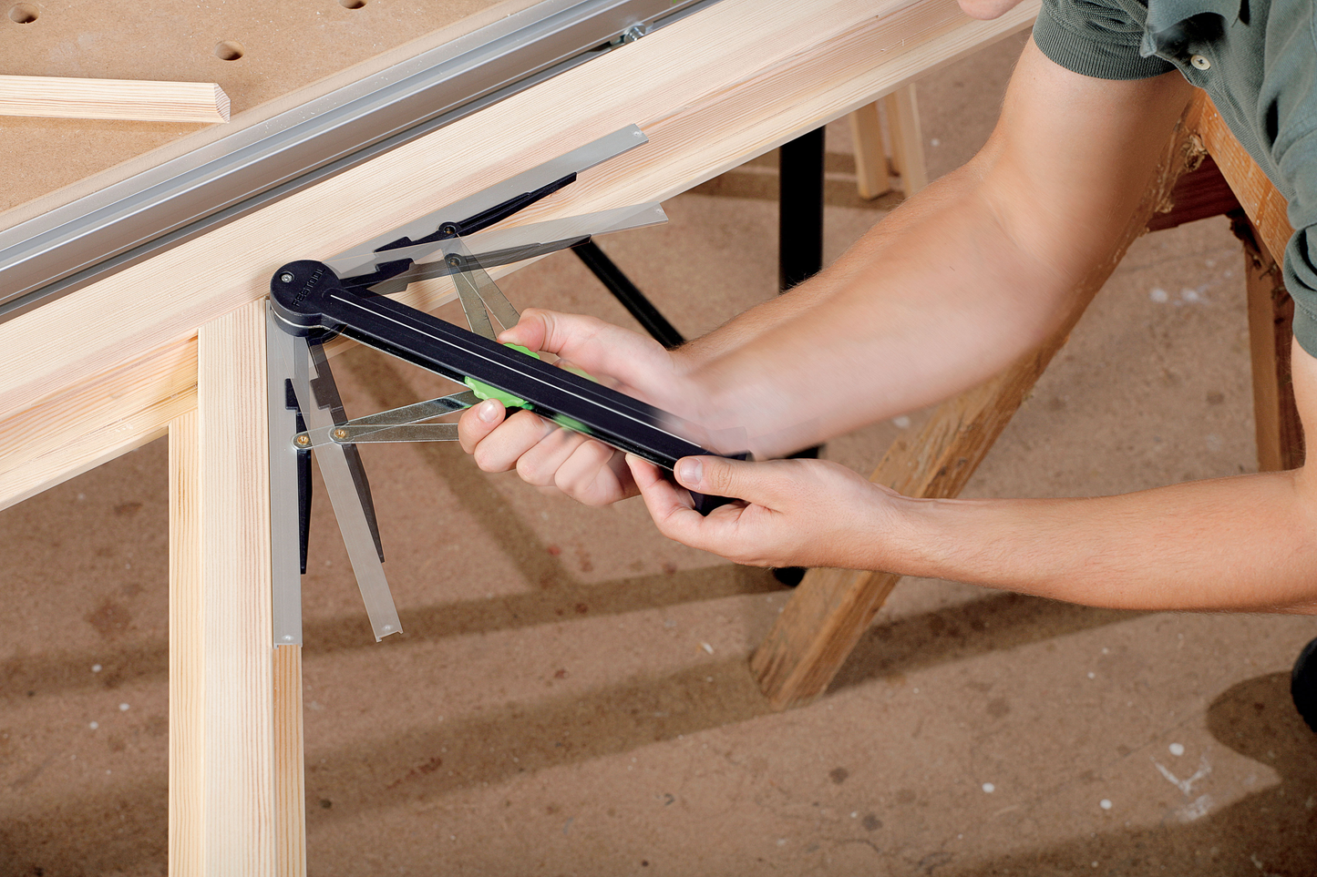 Person measuring and adjusting angle of wood frame with bevel gauge tool in home improvement and power tools collections