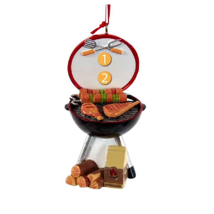 Round Christmas ornament shaped like a charcoal grill with meats, utensils, wood logs, and festive detailing in holiday décor collection
