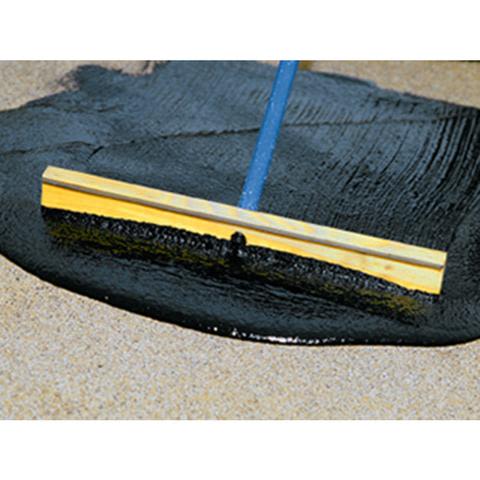 Tool spreading blacktop filler over cracked pavement for driveway repair in Paint & Supplies and Home Improvement collections