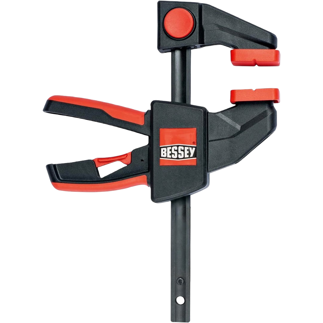 Black and red trigger clamp with ergonomic handle and quick-release mechanism for tools and home improvement projects
