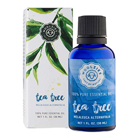 Blue glass bottle of Tea Tree essential oil with white and green botanical packaging for household cleaning and laundry supplies under $50