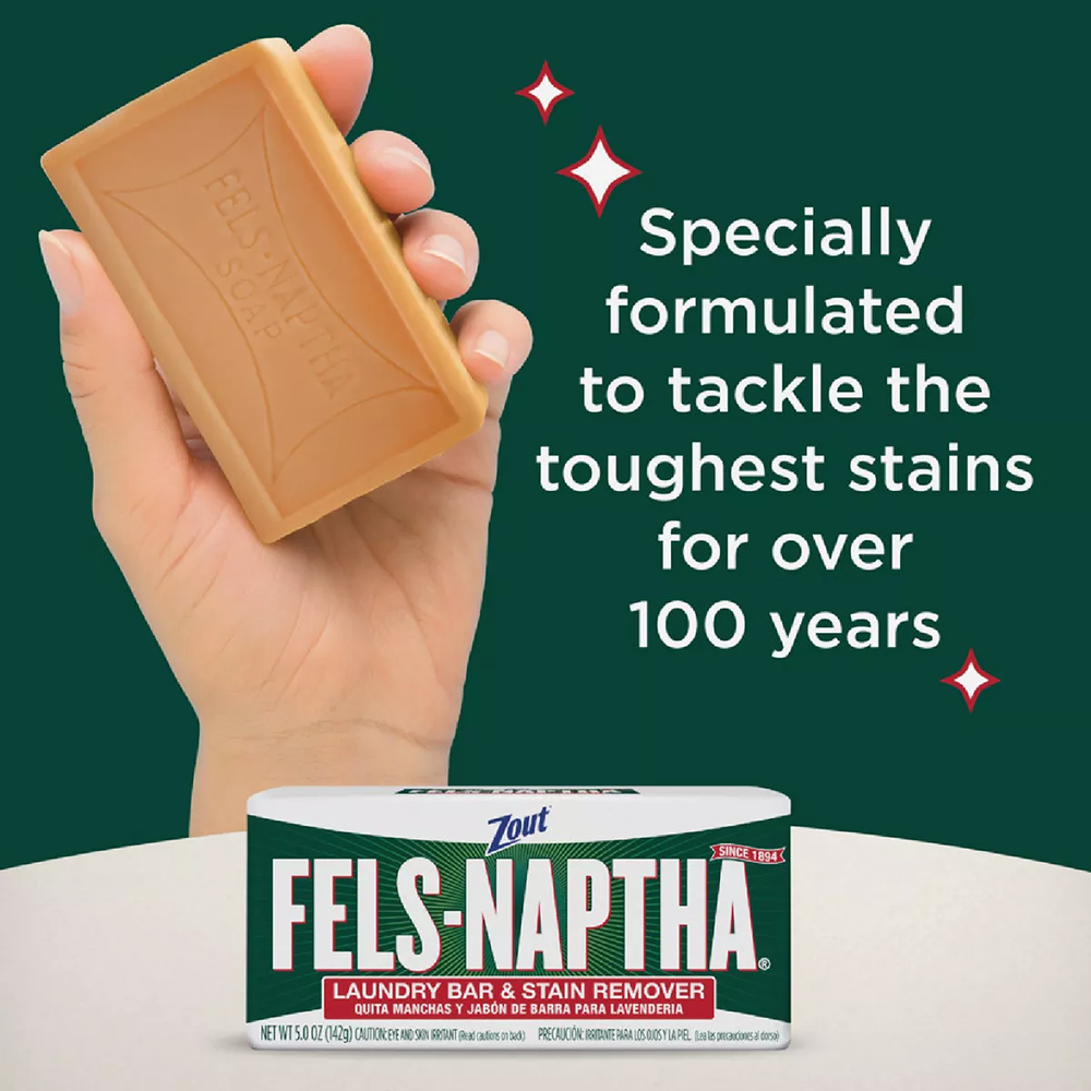 Hand holding brown Fels-Naptha soap bar above packaged laundry bar with text about tough stain removal history