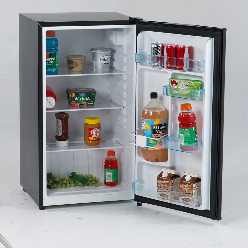 Compact black counterhigh refrigerator with stocked shelves including beverages, dairy, and snacks in kitchen appliances collection