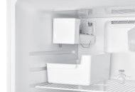 Automatic ice maker kit installed inside the freezer compartment with ice bucket and electrical wiring connections.