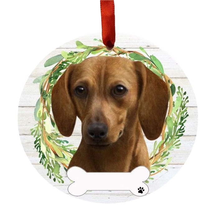 Round Christmas ornament with a brown Dachshund dog face inside a green leafy wreath and red hanging ribbon