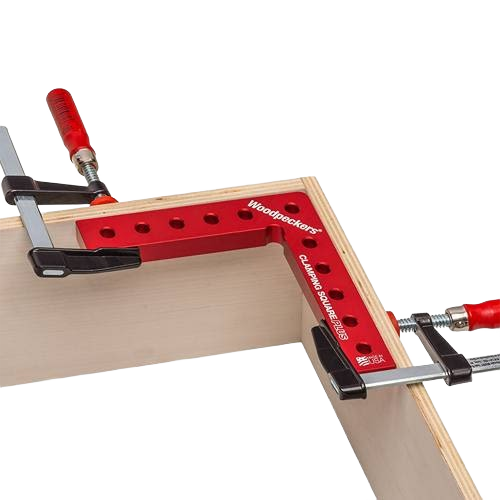 Red aluminum clamping square securing plywood at a precise right angle with adjustable clamps for woodworking tasks