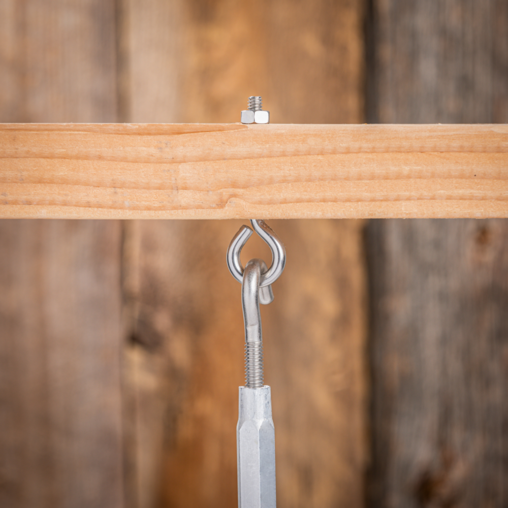 Stainless steel eye bolt with hex nut installed in wood for home improvement and fastening projects under $50