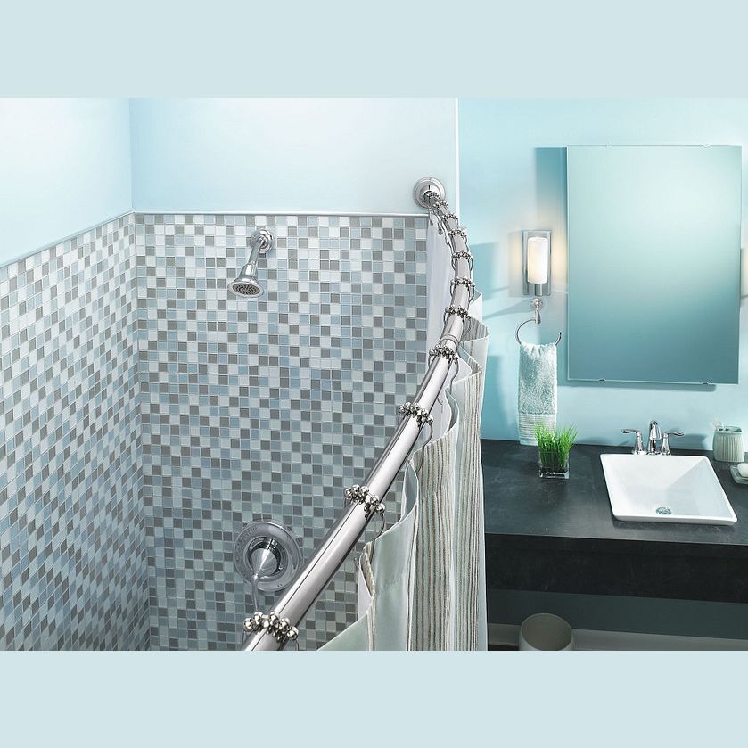 Curved chrome shower rod with matching rings holding a striped fabric curtain in a modern bathroom setting