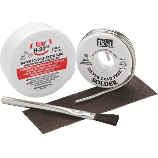 Silver-colored lead-free solder spool with water-soluble paste flux and small metal brush for home improvement tasks