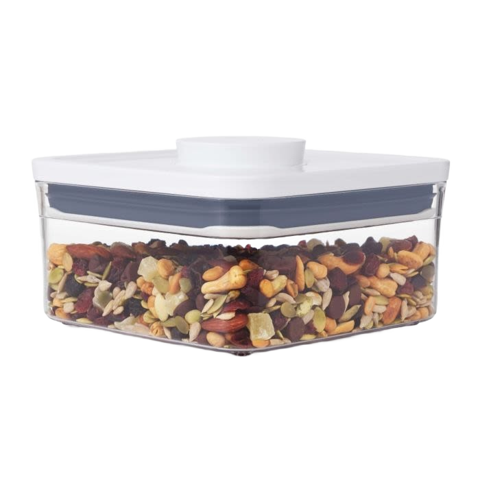 Clear square mini food storage container with white lid holding mixed nuts and dried fruit for kitchen organization