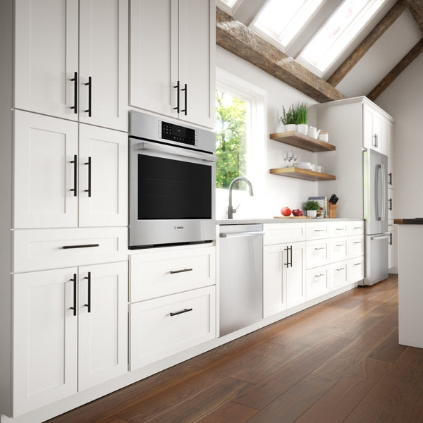 Modern kitchen with stainless steel 800 Series wall oven integrated into white cabinetry from Bosch appliances collection
