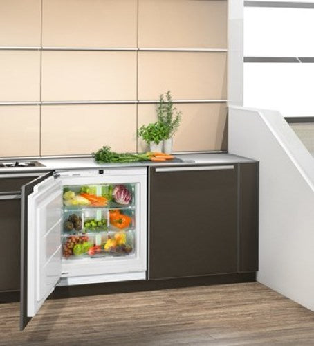 Built-in undercounter refrigerator with BioFresh drawers, visible fresh produce, in modern kitchen setting Appliances collection