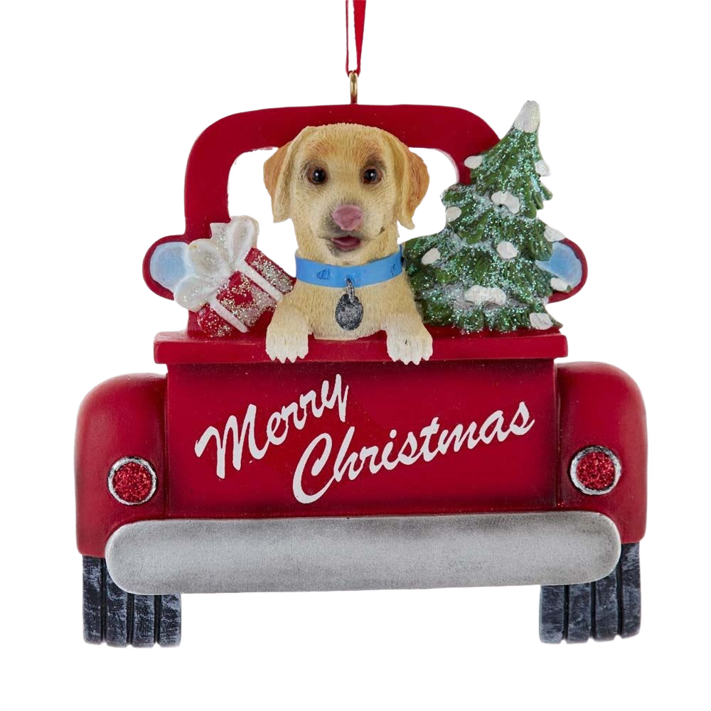Red truck ornament with yellow Labrador puppy wearing blue collar, Christmas tree, and gift saying Merry Christmas