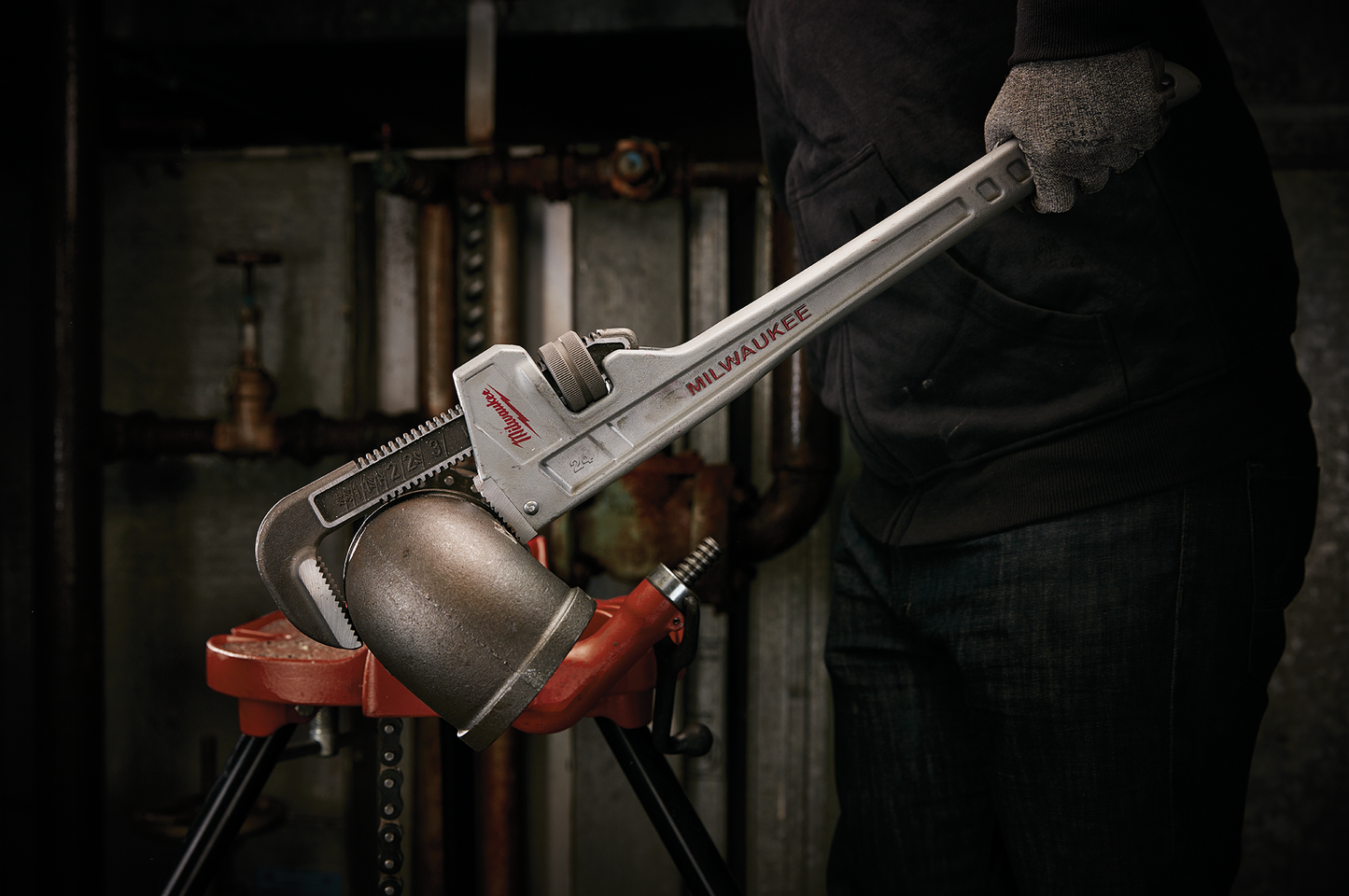 24-inch aluminum pipe wrench with ergonomic handle gripping pipe fitting for tools and home improvement use