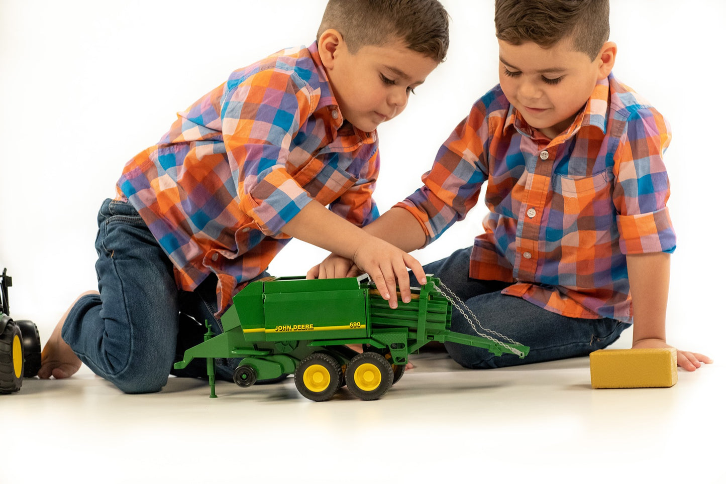 Two young boys playing with green Bruder John Deere Big Bale Press toy in Toys & Games and Bruder Toys collections