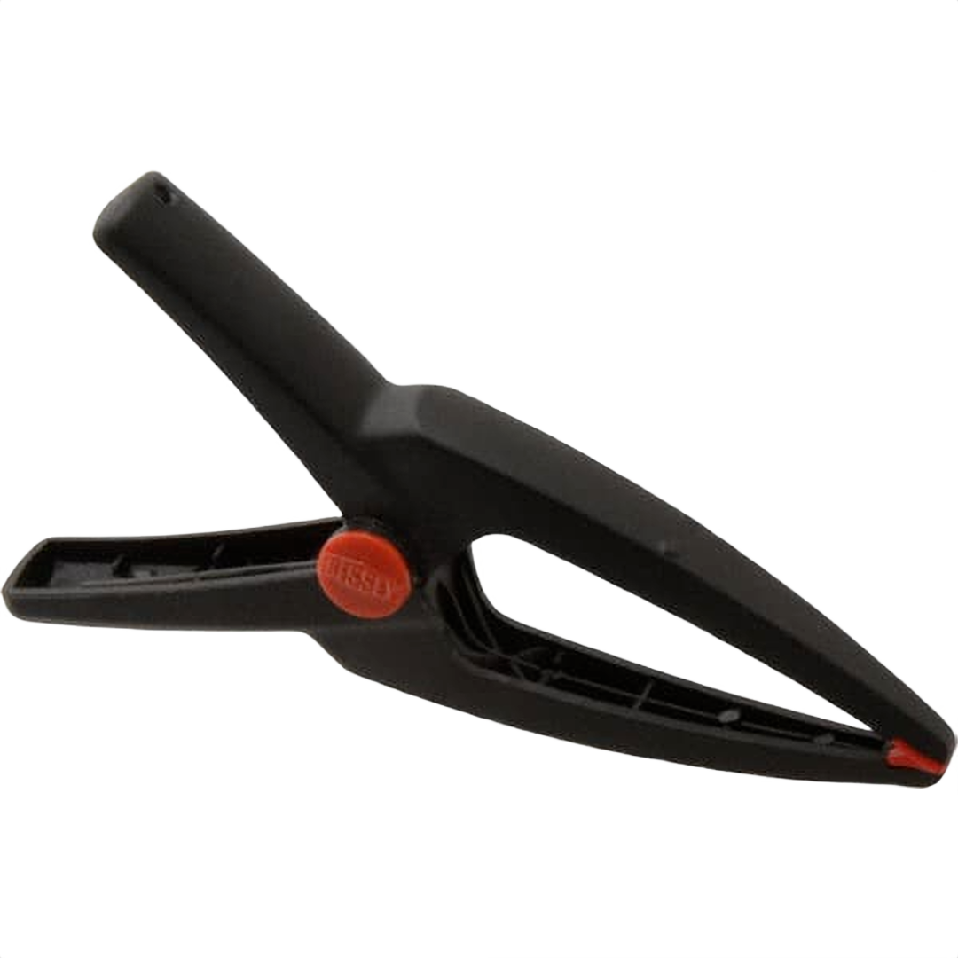 Black needle nose spring clamp with red pivot for precise gripping in home improvement and tool projects