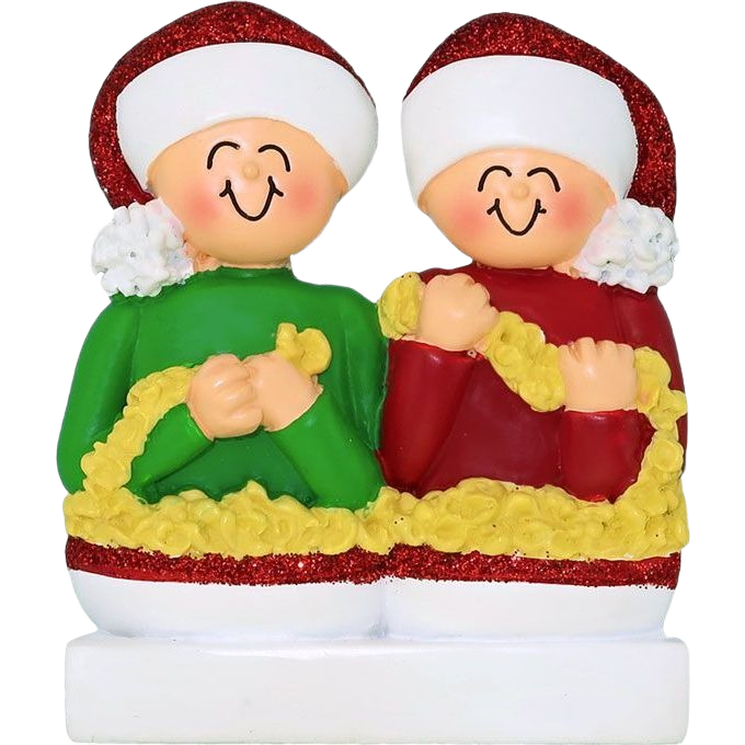 Smiling couple ornament in festive hats stringing yellow popcorn garland for Christmas tree decoration collection