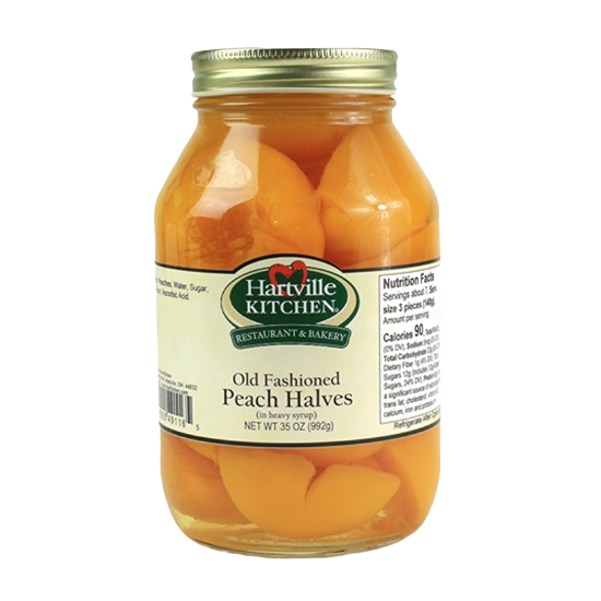Glass jar of Hartville Kitchen old fashioned peach halves packed in heavy syrup for jams and jellies collection