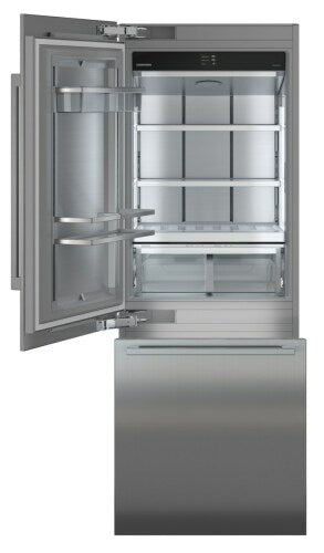 Built-in stainless steel refrigerator/freezer with open door showing adjustable glass shelves and bottom freezer drawer in appliances collection