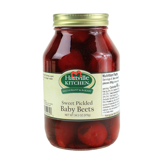 Glass jar of sweet pickled baby beets in brine from Hartville Kitchen Preserved Goods collection