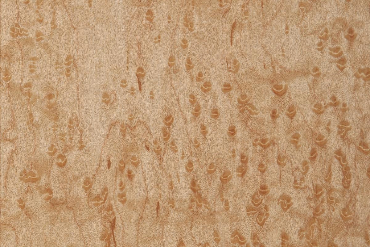 Close-up of birdseye maple wood grain pattern in light natural finish for woodworking and home improvement projects
